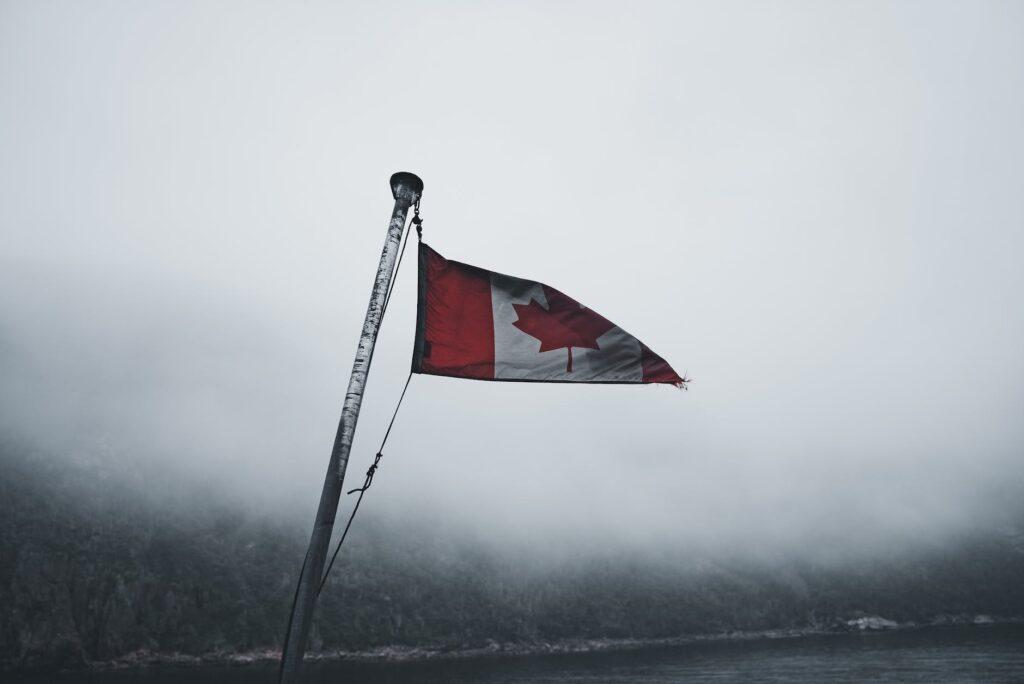 close up of a canadian flag in the foggy harbor