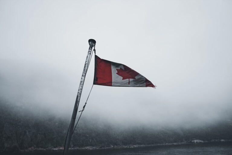 close up of a canadian flag in the foggy harbor